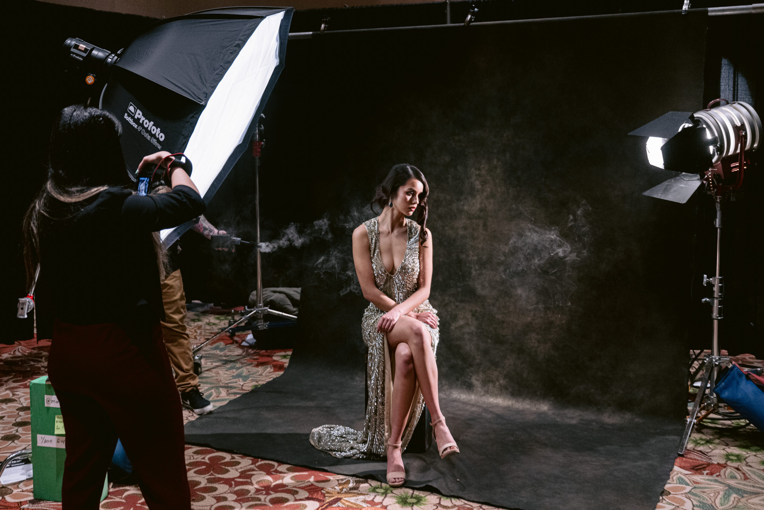 Educator demonstrating a beauty dish and softbox on stage